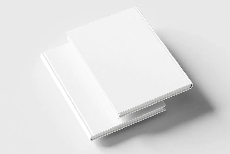 Two blank white hardcover books stacked at an angle on a pale gray background.
