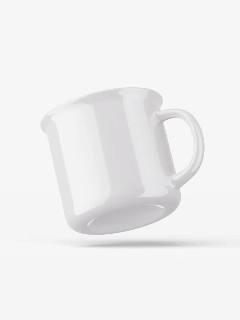 Glossy white camp-style ceramic mug tilted at an angle against a pale gray background.
