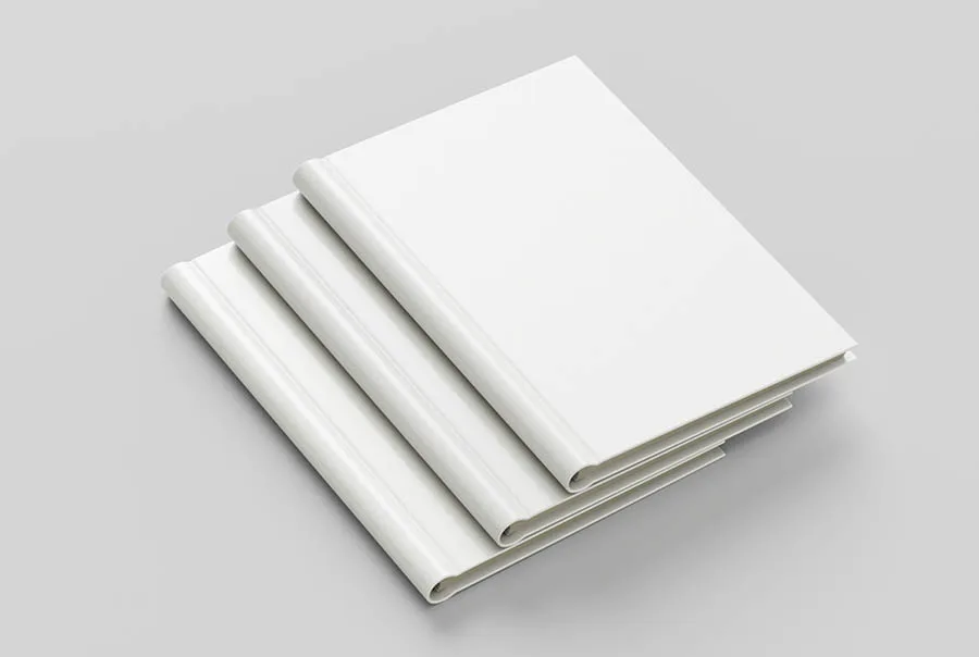 Three blank white spiral-bound books stacked diagonally on a light-gray surface.