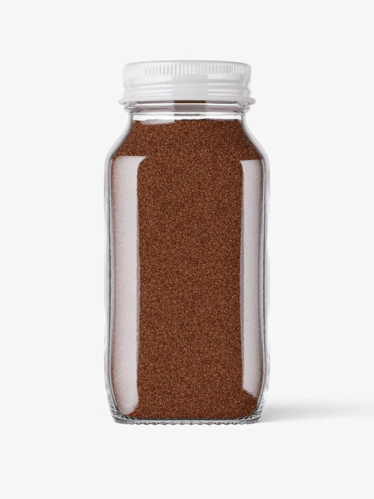 A square-sided clear spice jar filled with brown ground spice and closed with a light-colored cap.