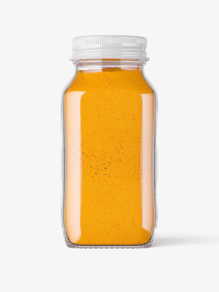 A clear square-sided spice jar filled with golden powder and topped with a light-colored cap.